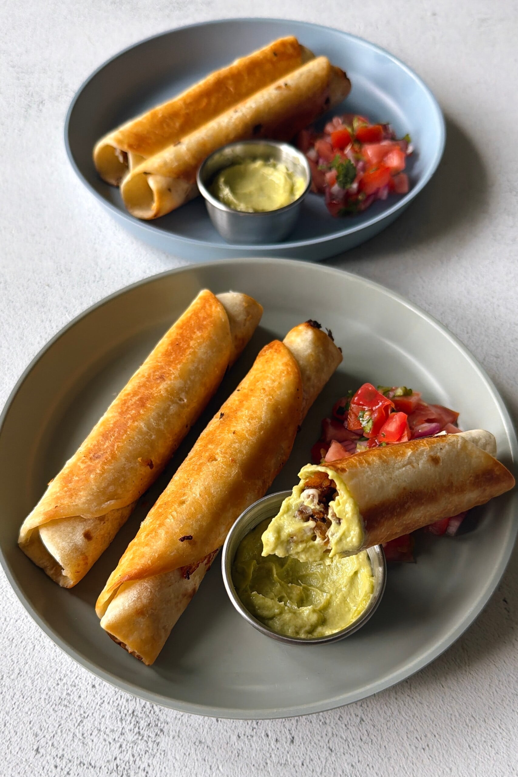 Ground beef taquitos served with pico de gallo and an avocado dip.