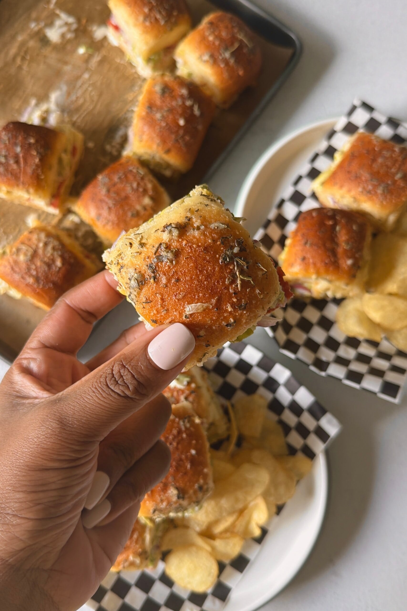 Italian grinder sliders served with potato chips.