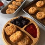 Cauliflower chicken nuggets served with ketchup and berries.
