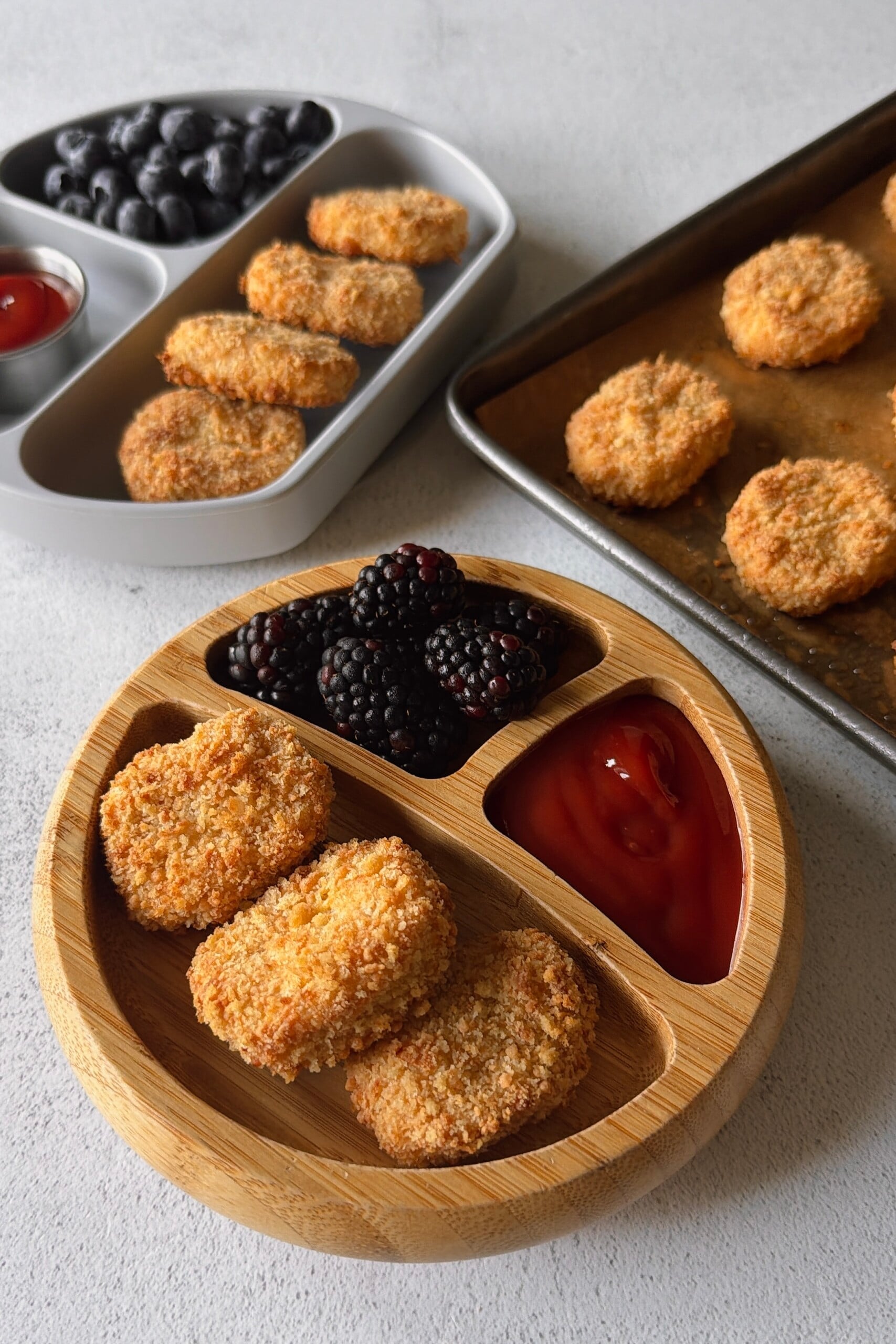 Cauliflower chicken nuggets served with ketchup and berries.