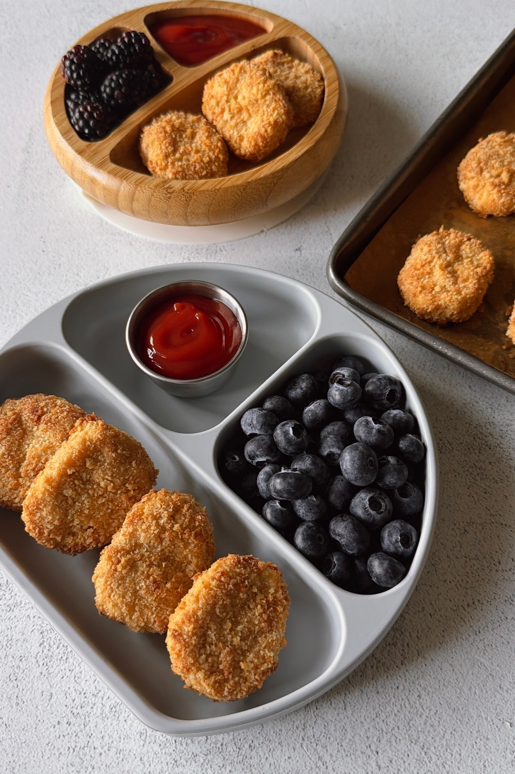 Cauliflower chicken nuggets served with ketchup and berries.