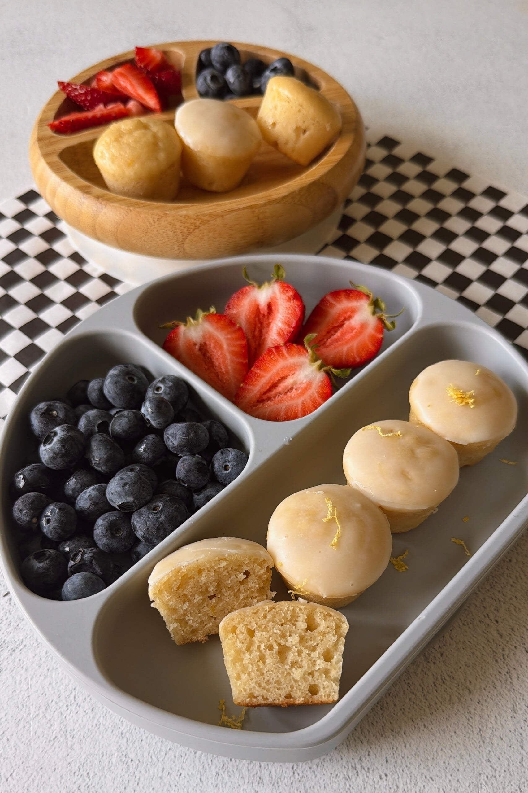 Mini lemon muffins served with berries.