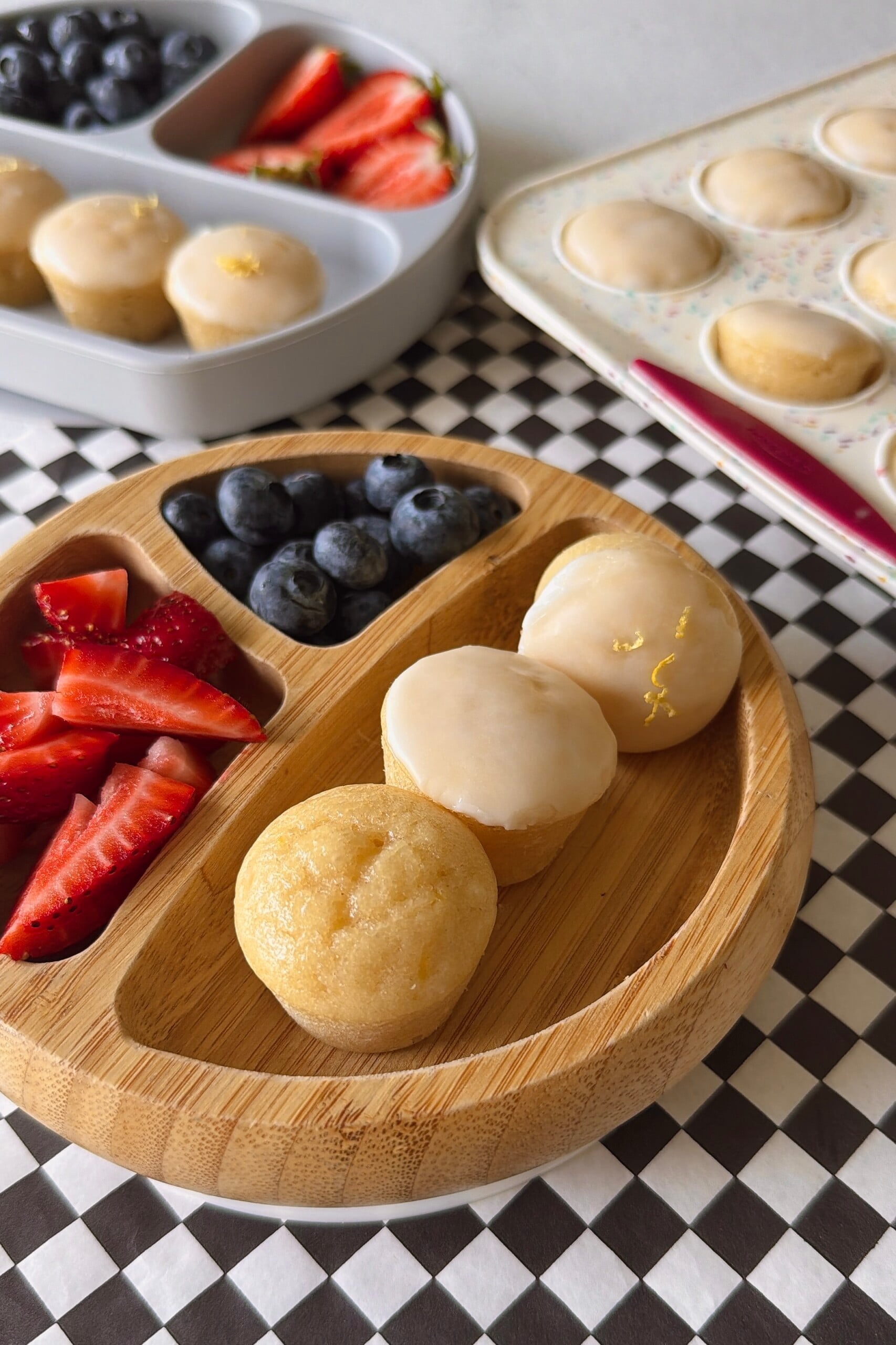 Mini lemon muffins served with berries.