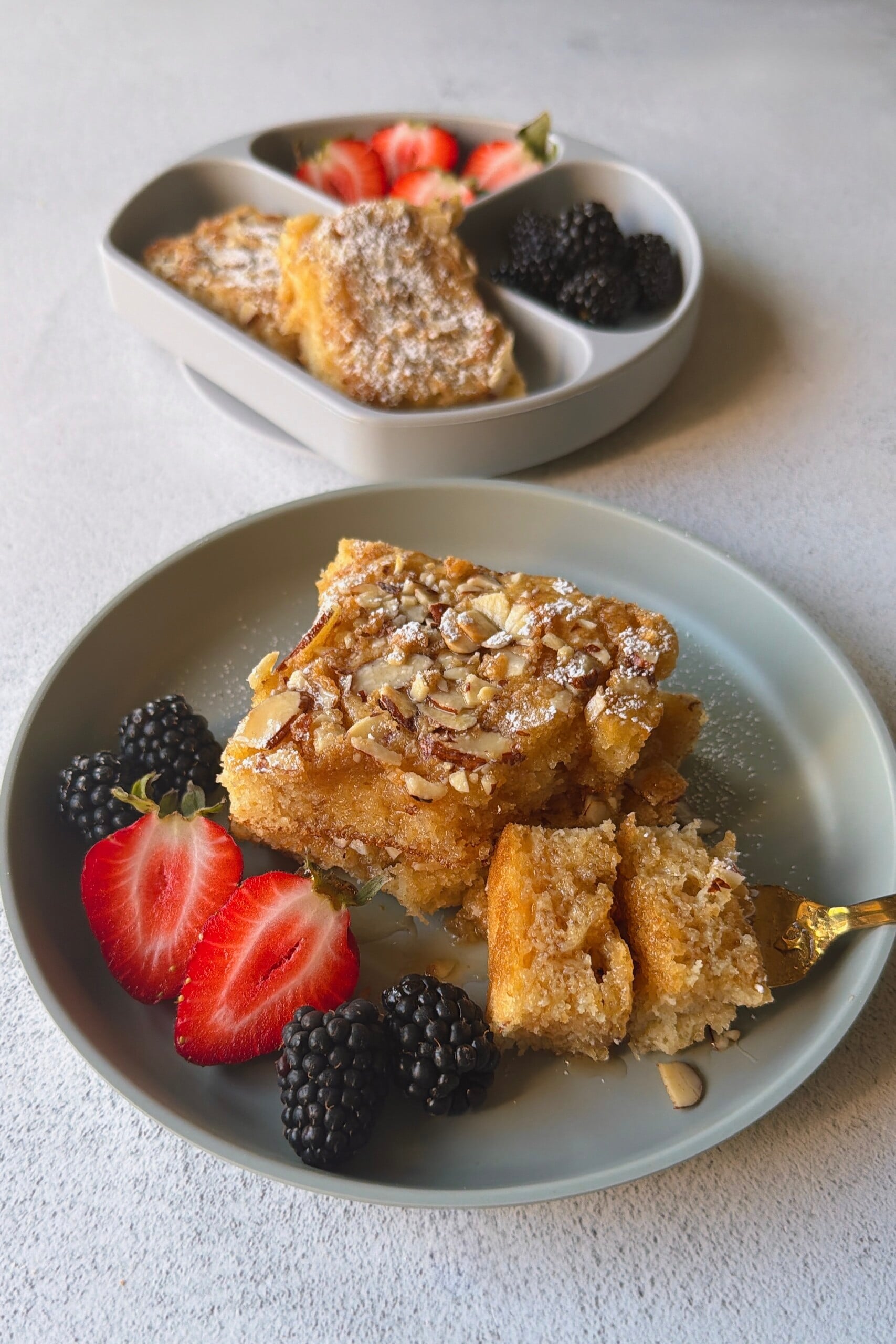 Almond croissant sheet pan pancakes served with berries.