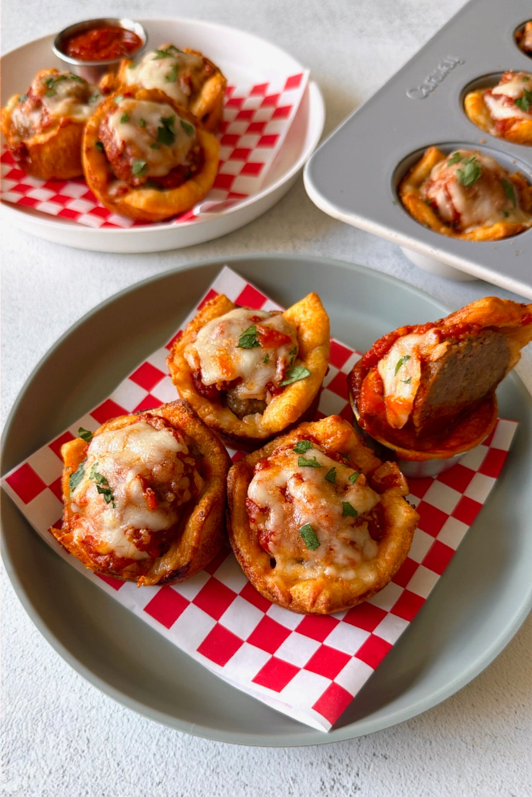Meatball cups served with marinara sauce for dipping.