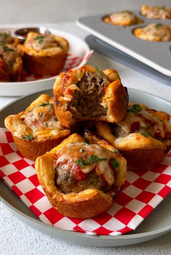 Meatball cups served with marinara sauce for dipping.
