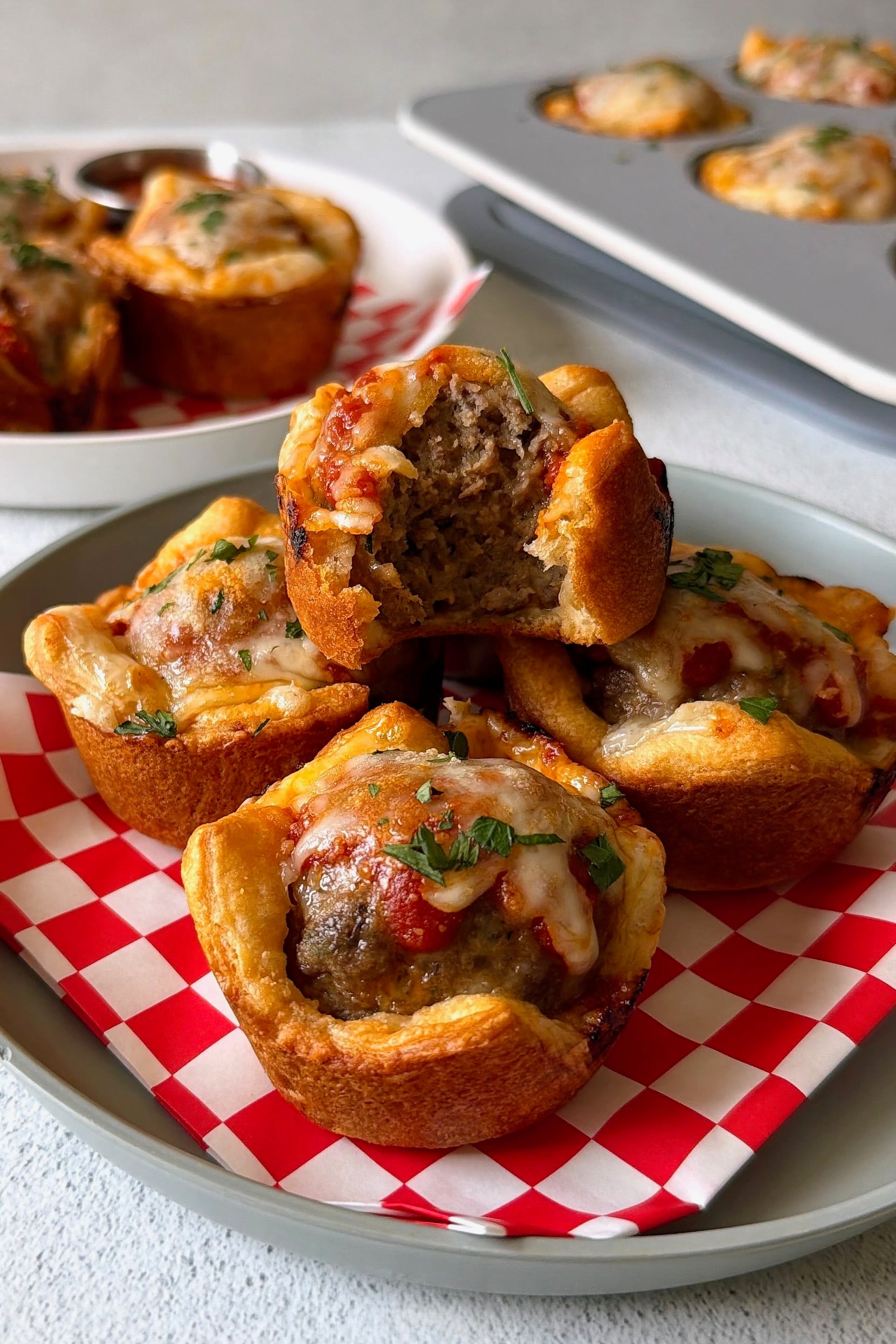 Meatball cups served with marinara sauce for dipping.