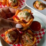 Meatball cups served with marinara sauce for dipping.