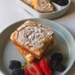 Almond croissant sheet pan pancakes served with berries.