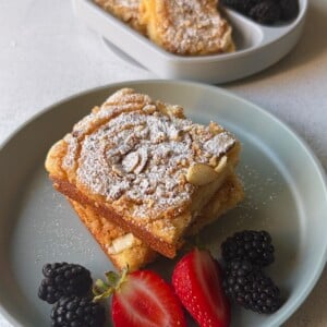 Almond croissant sheet pan pancakes served with berries.