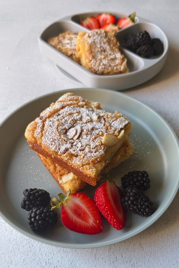 Almond croissant sheet pan pancakes served with berries.
