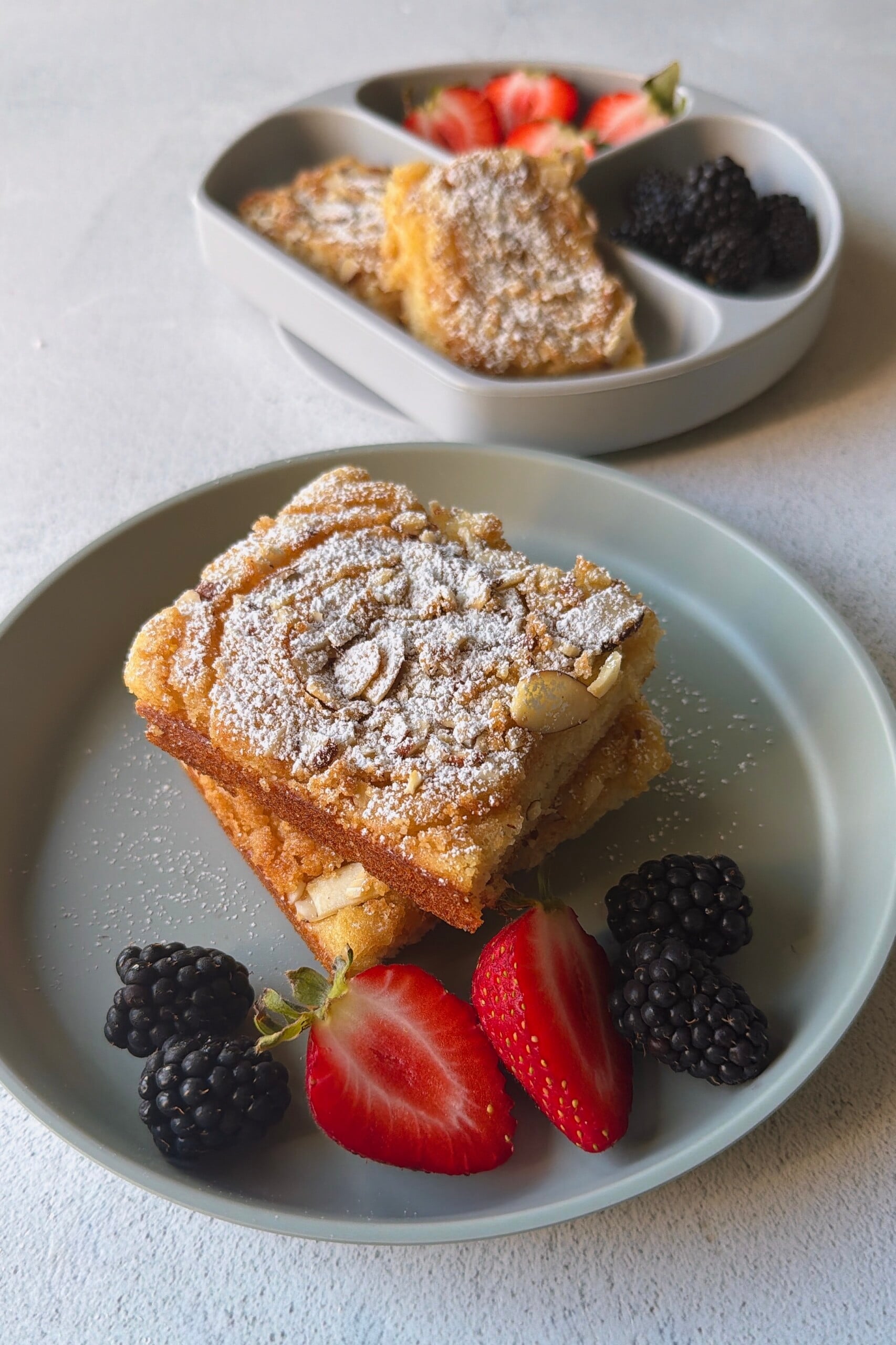 Almond croissant sheet pan pancakes served with berries.