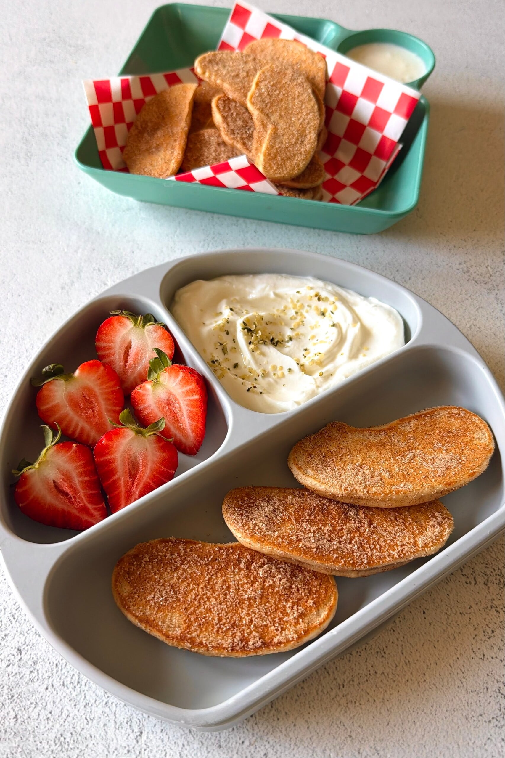 Apple pancake dippers served with strawberries and a Greek yogurt dip.
