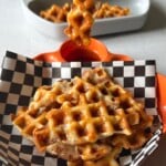 Bacon waffles served with berries and maple syrup.
