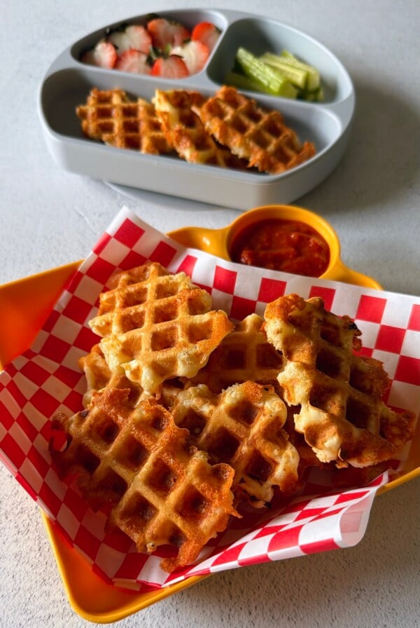 Mozzarella stick waffles served with marinara sauce.