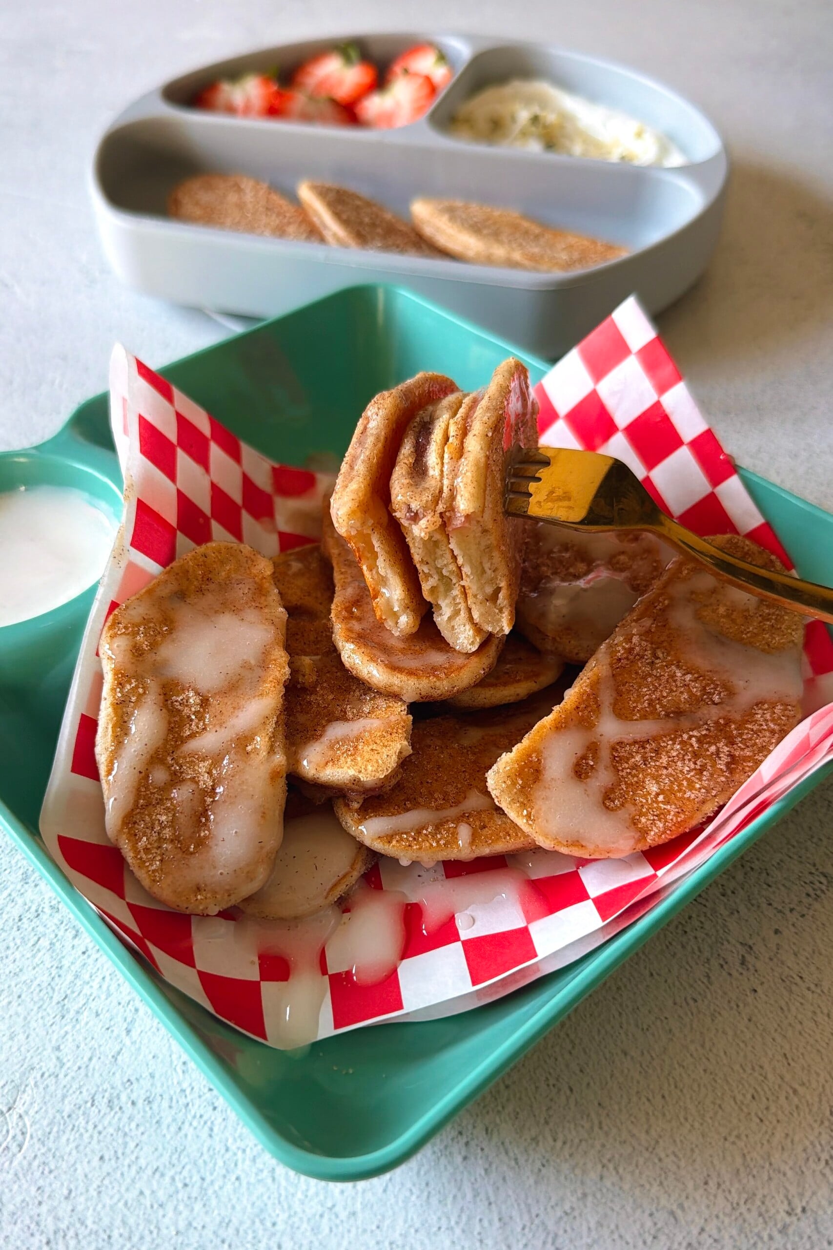 Apple pancake dippers served with strawberries and a Greek yogurt dip.
