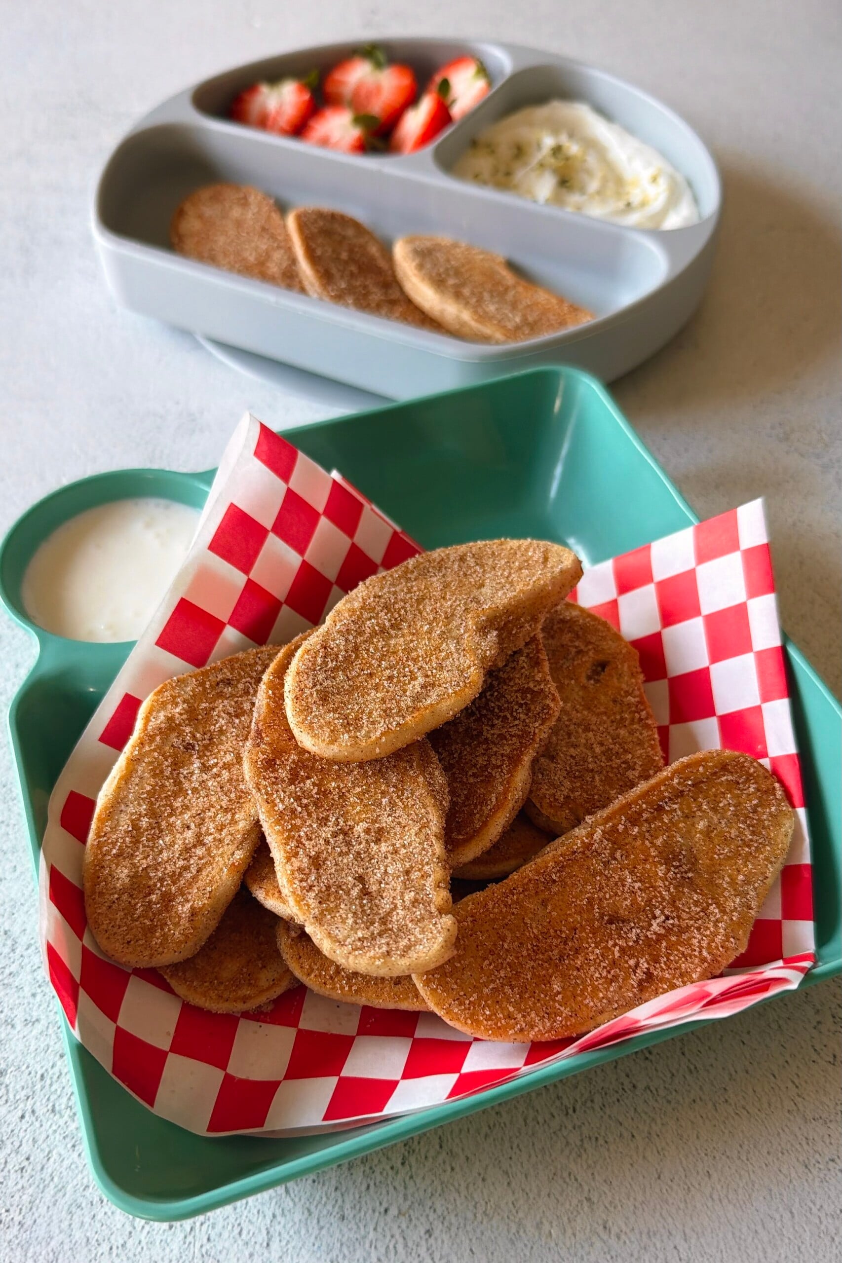Apple pancake dippers served with strawberries and a Greek yogurt dip.