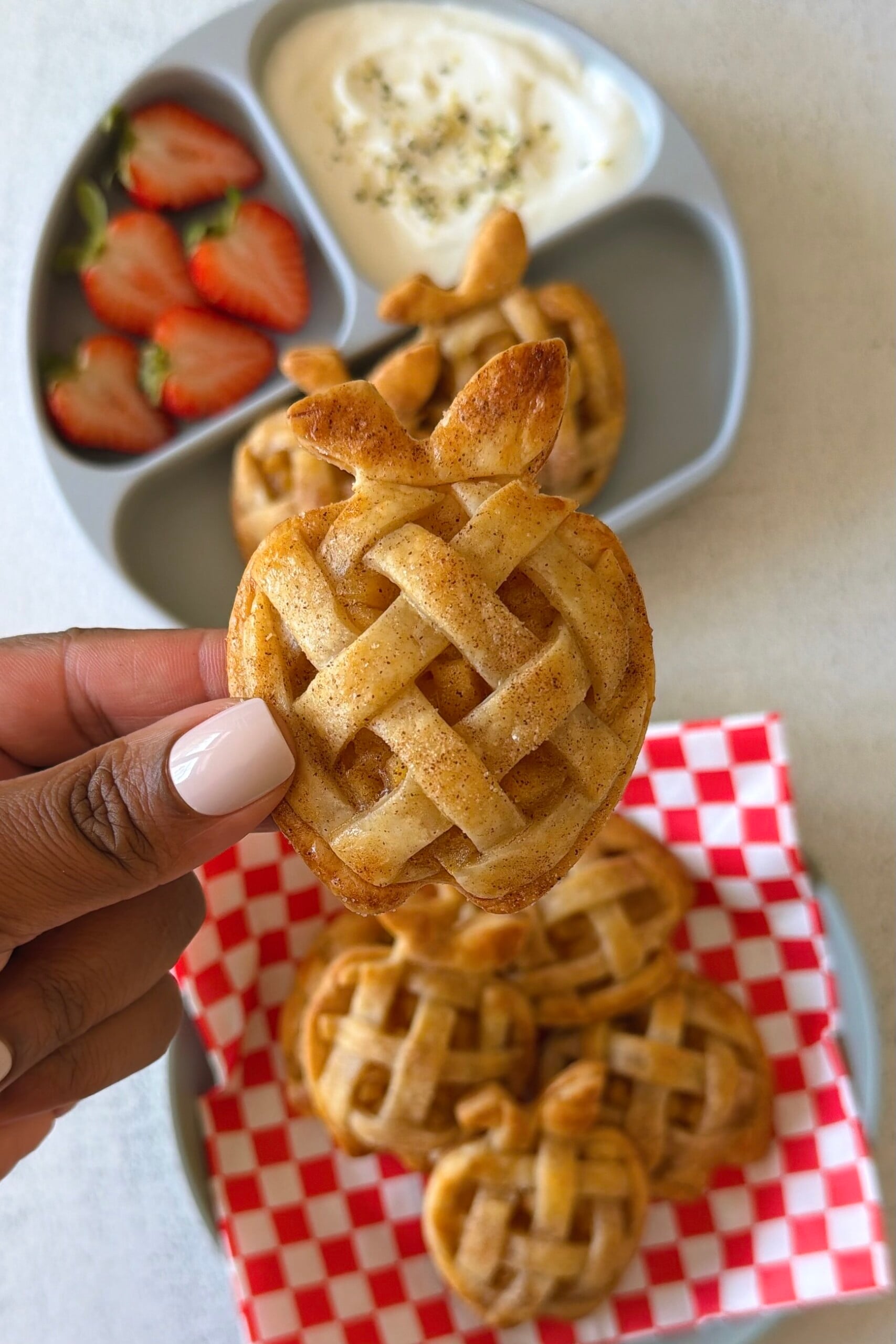 Mini apple pies served with strawberries and yogurt.