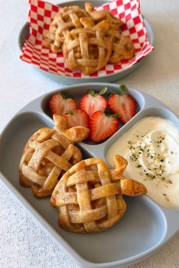 Mini apple pies served with strawberries and yogurt.
