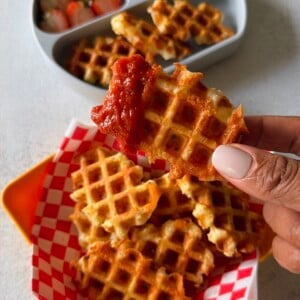 Mozzarella stick waffles served with marinara sauce.