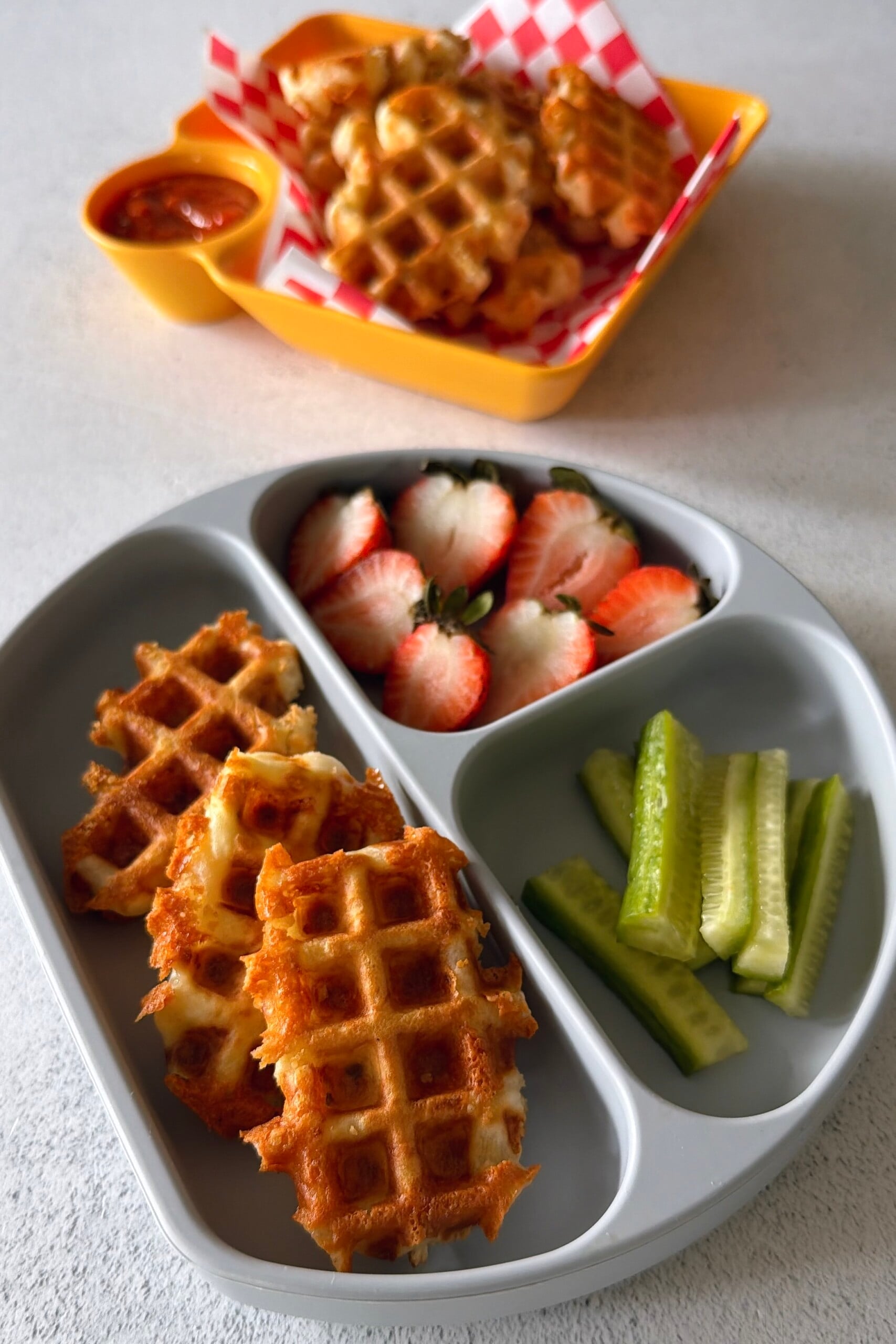 Mozzarella stick waffles served with marinara sauce.